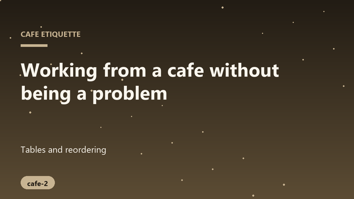 A person typing on a laptop at a small cafe table with a nearly empty coffee mug beside them.